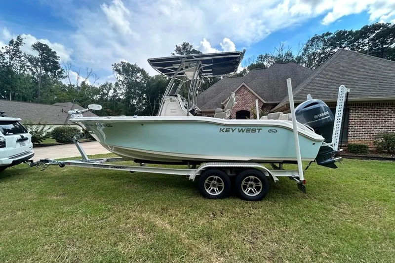 Slide: The Image of 2022 Key West 219 FS boat on trailer, parked in residential driveway. - 5