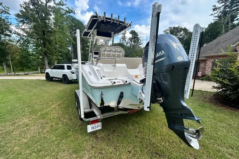 Slide: The Image of 2022 Key West 219 FS boat on trailer with Yamaha engine, parked on grass. - 8