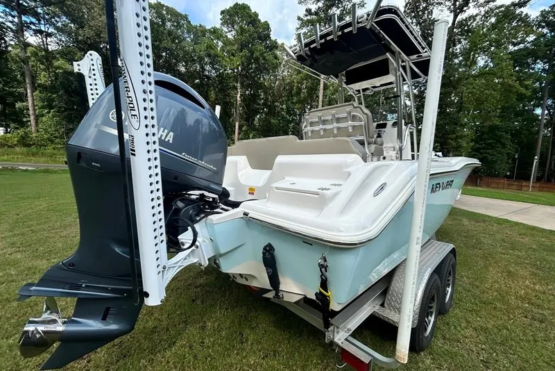 Slide: The Image of 2022 Key West 219 FS boat on trailer with Yamaha outboard motor, parked on grass. - 9
