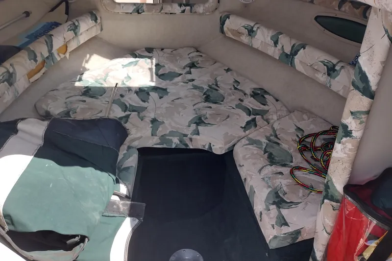 Slide: The Image of 1999 Sea Ray 215 Express Cruiser cabin interior with floral upholstery. - 11