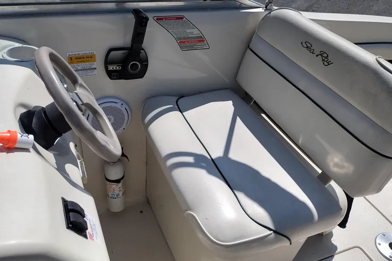Slide: The Image of 1999 Sea Ray 215 Express Cruiser cockpit with steering wheel and seating. - 15