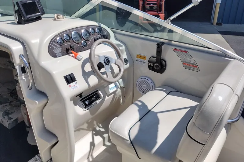 Slide: The Image of 1999 Sea Ray 215 Express Cruiser dashboard with steering wheel and control panel. - 22