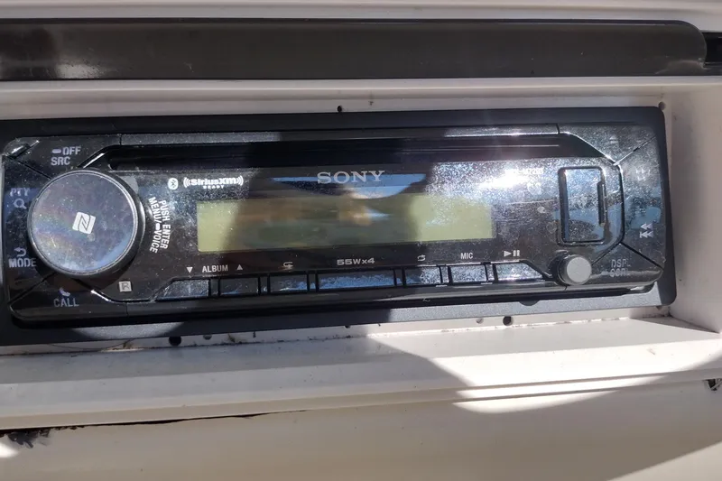 Slide: The Image of Sony stereo system on 1999 Sea Ray 215 Express Cruiser boat dashboard. - 24