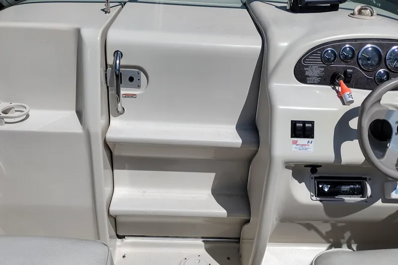 Slide: The Image of 1999 Sea Ray 215 Express Cruiser dashboard with steering wheel and control panel. - 26