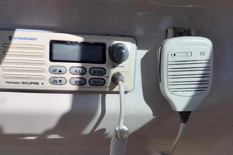 Slide: The Image of 1999 Sea Ray 215 Express Cruiser radio system with microphone and control panel. - 28