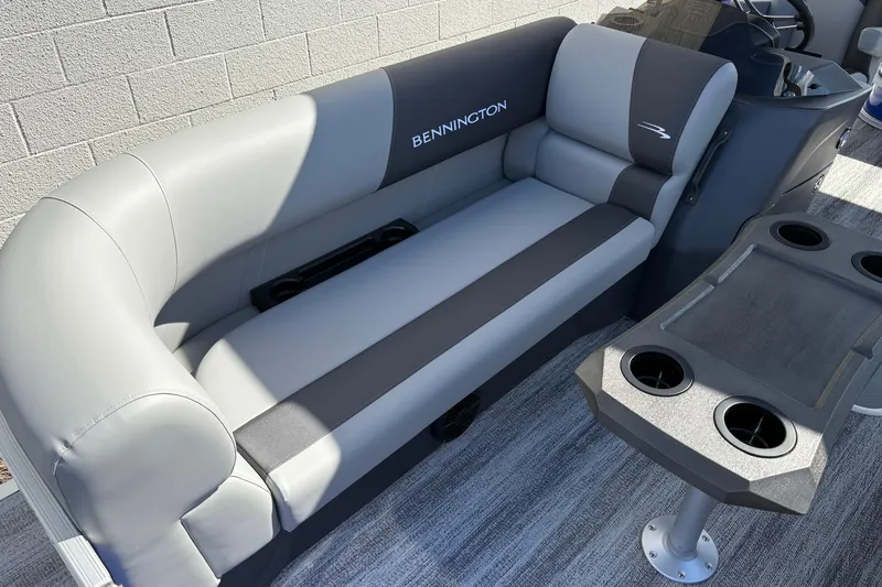 Slide: The Image of 2026 Bennington 21 SSB boat interior with gray seating and cup holders. - 13