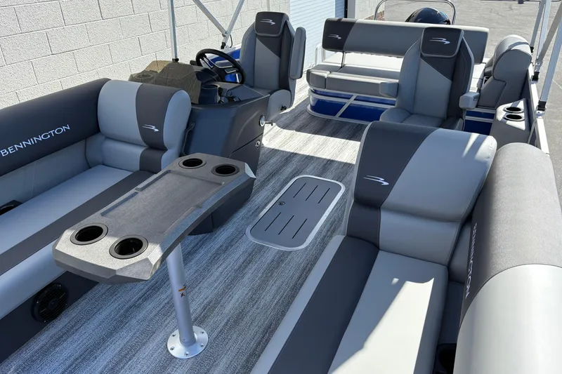 Slide: The Image of 2026 Bennington 21 SSB pontoon boat interior with gray seating and cup holders. - 14