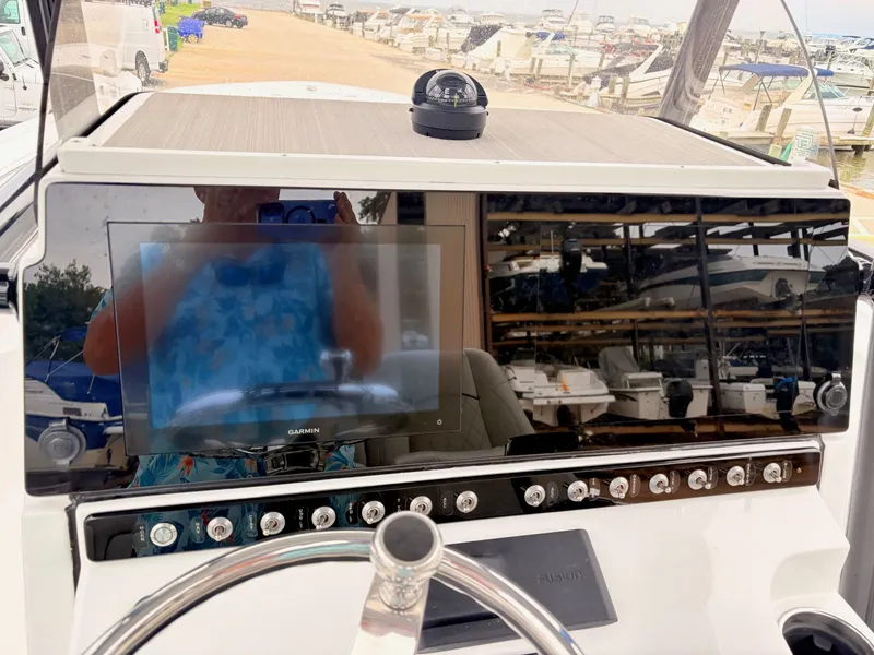Slide: The Image of 2022 Sportsman 241 Heritage boat dashboard with Garmin display and compass. - 17
