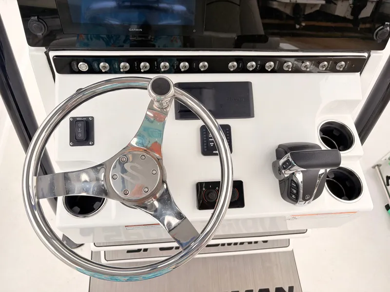 Slide: The Image of 2022 Sportsman 241 Heritage boat dashboard with steering wheel and controls. - 18