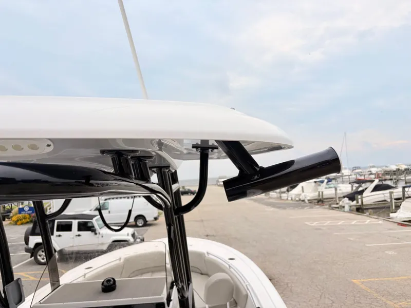 Slide: The Image of 2022 Sportsman 241 Heritage boat detail at marina, showcasing rod holder and T-top. - 22