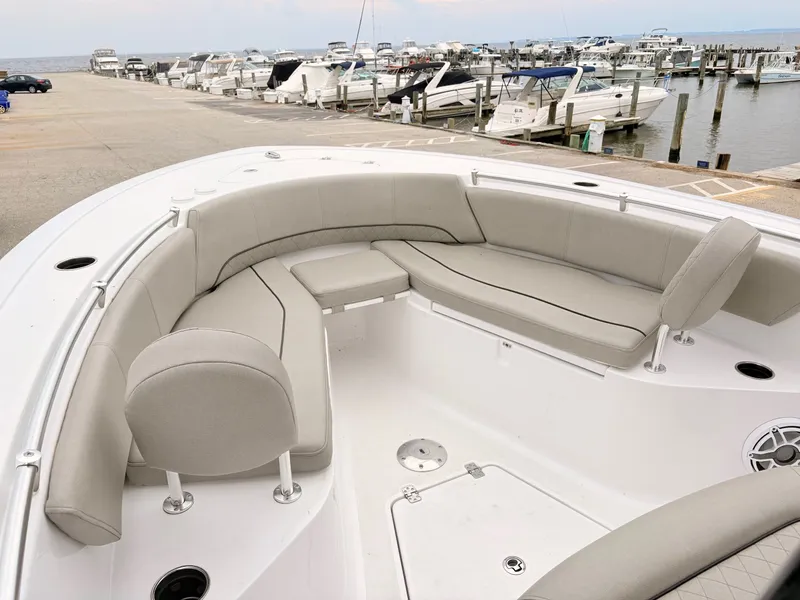 Slide: The Image of 2022 Sportsman 241 Heritage boat with spacious seating at a marina. - 28