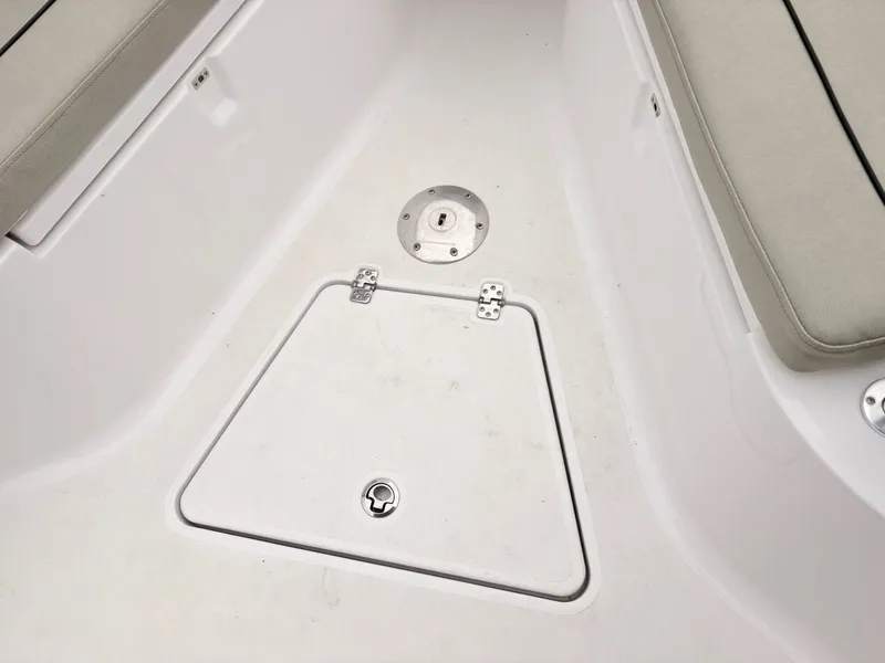 Slide: The Image of 2022 Sportsman 241 Heritage boat interior with storage compartment and seating. - 29