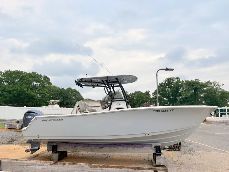 Slide: The Image of 2022 Sportsman 241 Heritage boat on display, featuring Yamaha engine, outdoors. - 3
