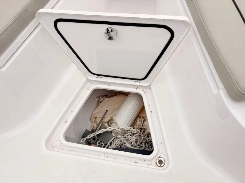 Slide: The Image of Open storage compartment on 2022 Sportsman 241 Heritage boat with ropes and equipment. - 30