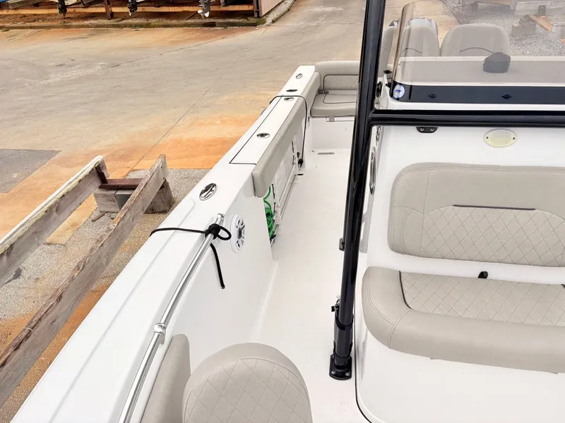 Slide: The Image of 2022 Sportsman 241 Heritage boat interior with beige seating and sleek design. - 37