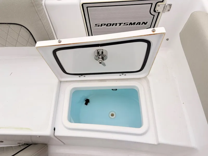 Slide: The Image of Open storage compartment on 2022 Sportsman 241 Heritage boat, featuring a clean interior. - 44