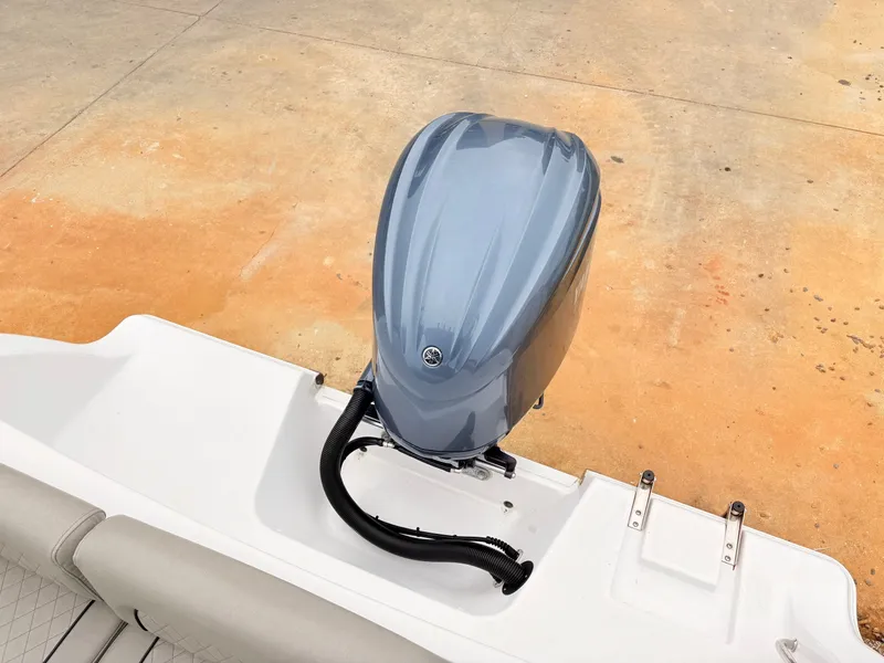 Slide: The Image of 2022 Sportsman 241 Heritage boat with sleek outboard motor on a concrete surface. - 48