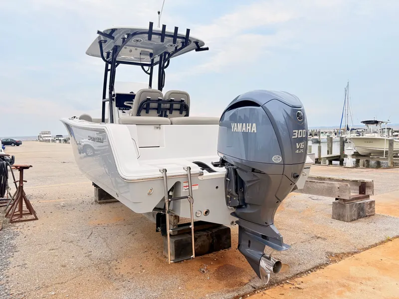 Slide: The Image of 2022 Sportsman 241 Heritage boat with Yamaha 300 V6 engine at a marina. - 6