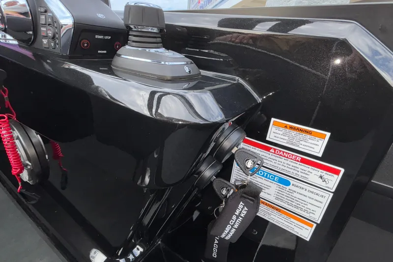 Slide: The Image of Control panel of 2026 Viaggio D28UW A-T boat with safety warnings and key tether. - 12