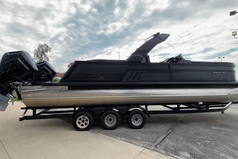 Slide: The Image of 2026 Viaggio D28UW A-T pontoon boat on trailer under cloudy sky. - 3