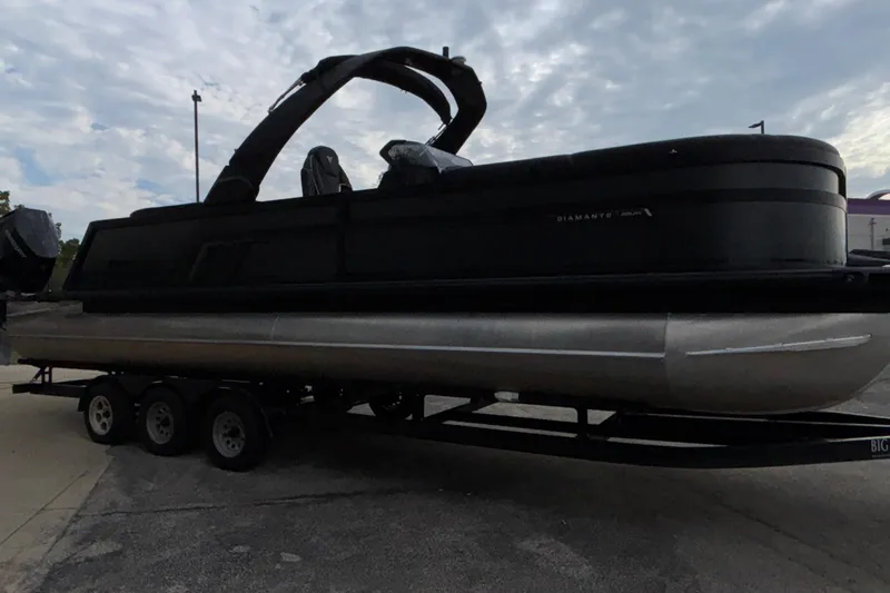 Slide: The Image of 2026 Viaggio D28UW A-T pontoon boat on trailer, sleek black design. - 4