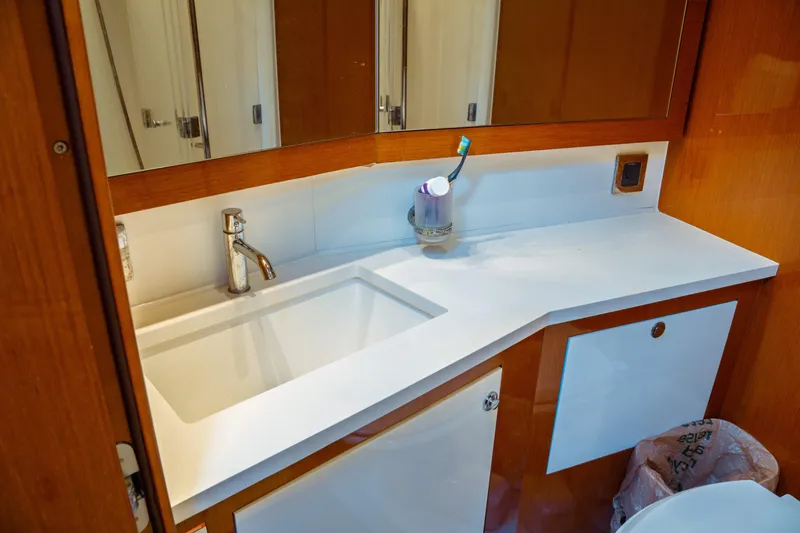 Slide: The Image of Luxurious bathroom sink in 2016 Beneteau Oceanis 60 yacht, featuring modern fixtures and cabinetry. - 10