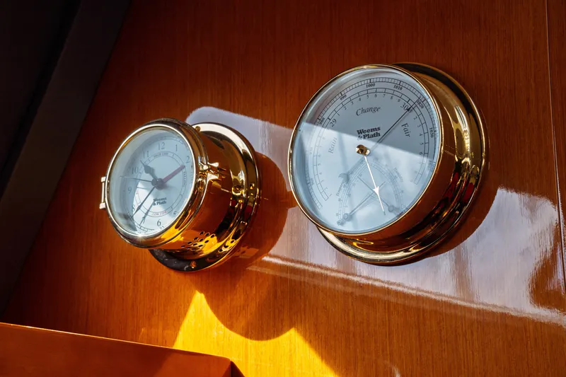 Slide: The Image of Brass clock and barometer on 2016 Beneteau Oceanis 60 yacht interior. - 15