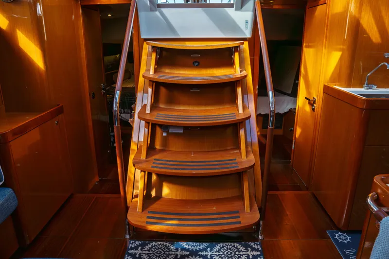 Slide: The Image of Interior of 2016 Beneteau Oceanis 60 yacht with wooden stairs and elegant design. - 17