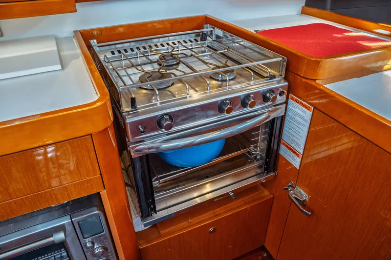 Slide: The Image of Galley kitchen in 2016 Beneteau Oceanis 60 yacht with stove and oven. - 22