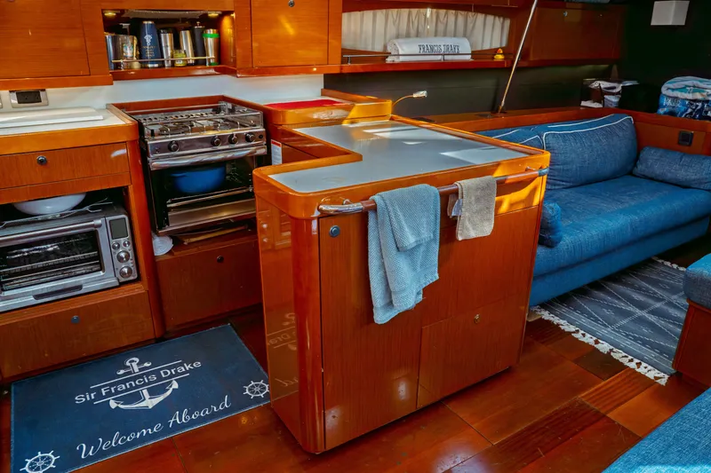 Slide: The Image of Luxurious interior of 2016 Beneteau Oceanis 60 yacht with kitchen and seating area. - 23