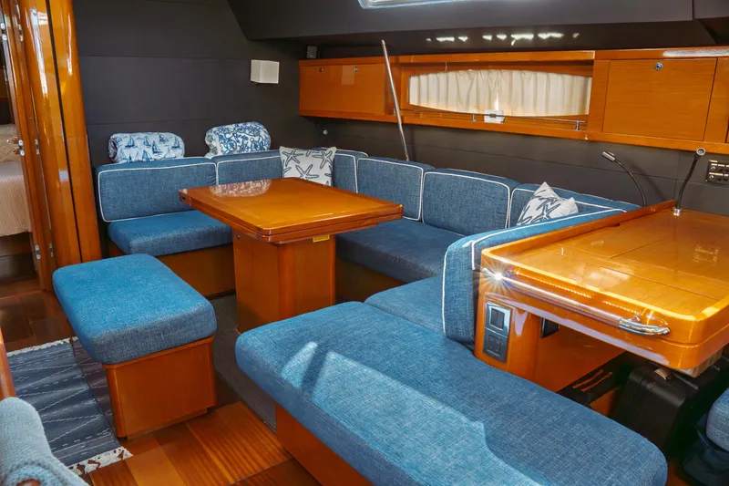 Slide: The Image of Luxurious interior of 2016 Beneteau Oceanis 60 yacht with blue seating and wooden finishes. - 27
