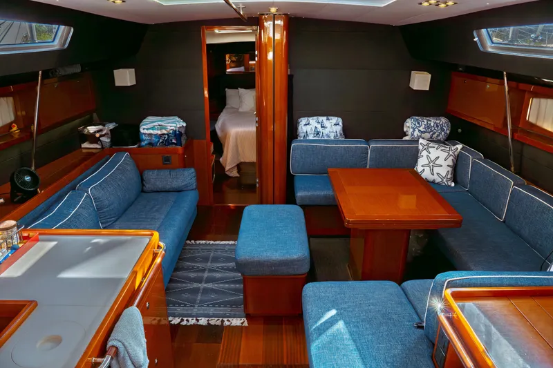 Slide: The Image of Luxurious interior of 2016 Beneteau Oceanis 60 yacht with blue seating and wooden accents. - 28