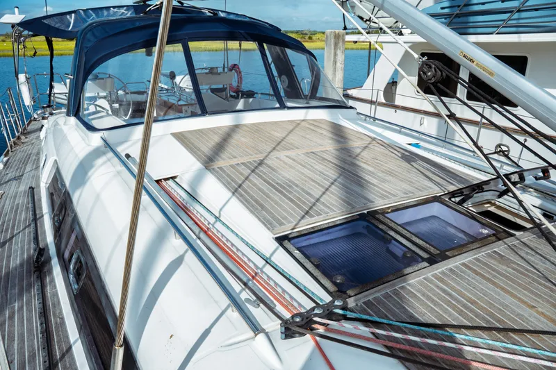 Slide: The Image of 2016 Beneteau Oceanis 60 yacht with spacious deck and sleek design, docked by the water. - 40