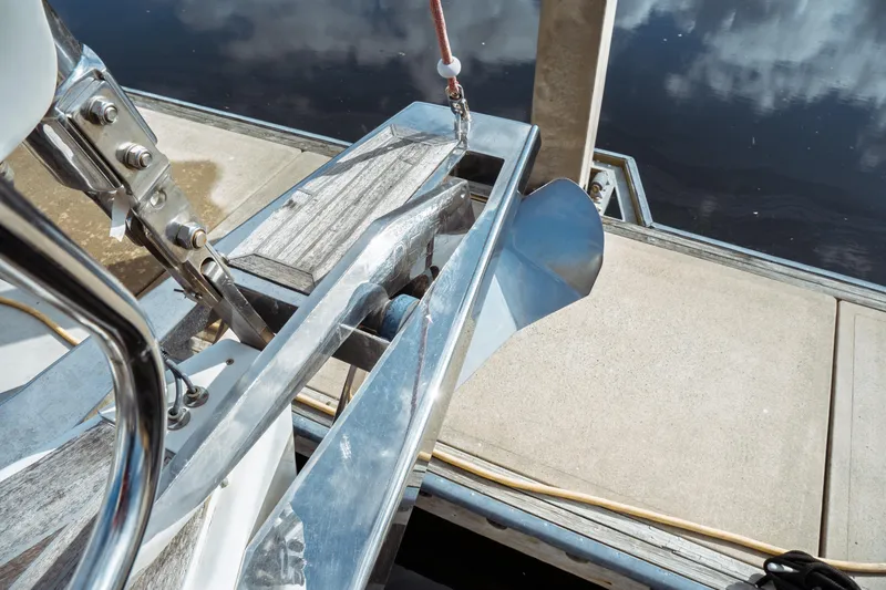 Slide: The Image of Beneteau Oceanis 60 (2016) anchor detail at dockside, showcasing polished metal and wood elements. - 44