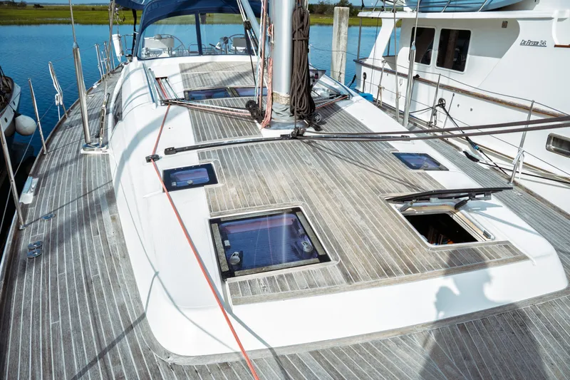 Slide: The Image of Beneteau Oceanis 60 sailboat deck, 2016 model, with open hatches and wooden finish. - 47