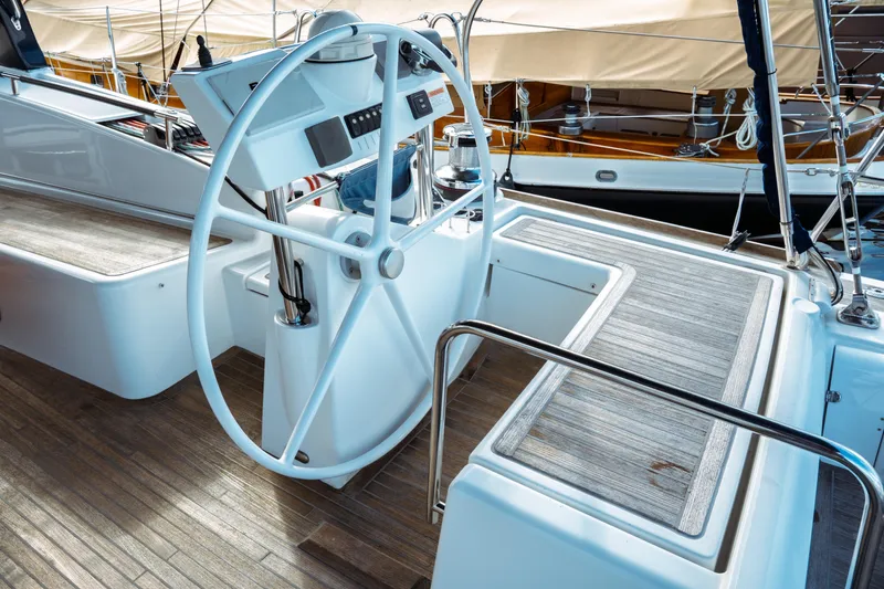 Slide: The Image of Steering wheel of 2016 Beneteau Oceanis 60 yacht with wooden deck. - 53