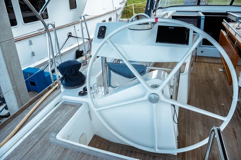 Slide: The Image of Cockpit of 2016 Beneteau Oceanis 60 yacht with large steering wheel and navigation equipment. - 59
