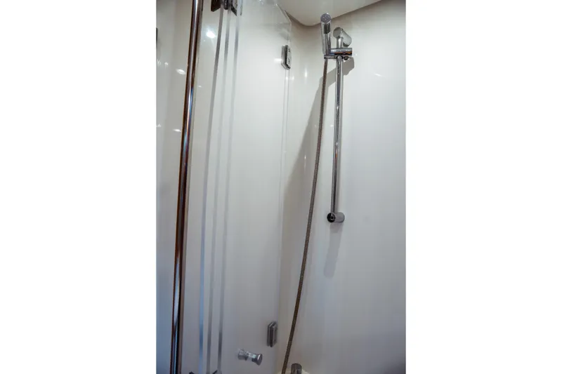 Slide: The Image of Shower area in 2016 Beneteau Oceanis 60 yacht, featuring sleek chrome fixtures. - 6