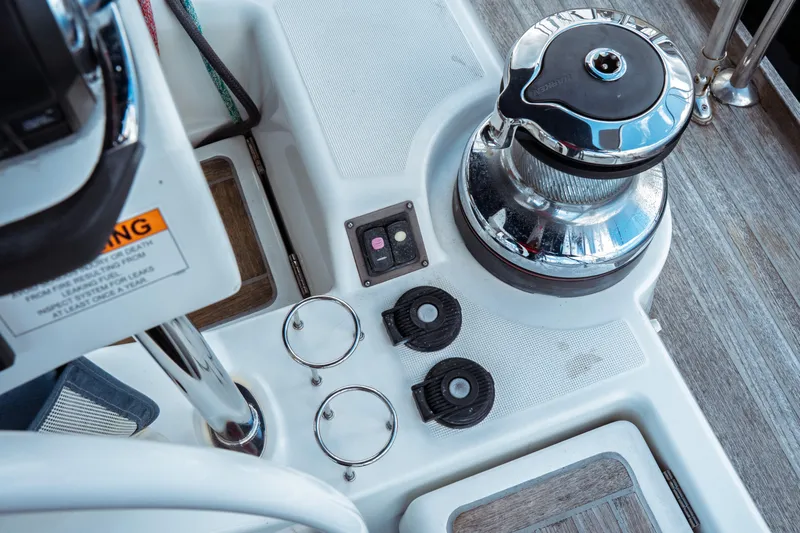 Slide: The Image of Cockpit controls of a 2016 Beneteau Oceanis 60 yacht, featuring winch and deck fittings. - 61