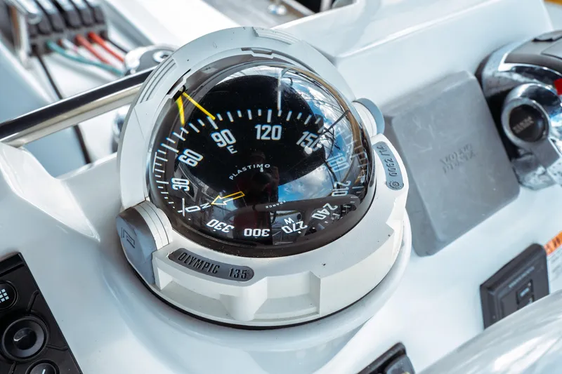 Slide: The Image of Compass on 2016 Beneteau Oceanis 60 yacht dashboard, featuring navigation instruments. - 64