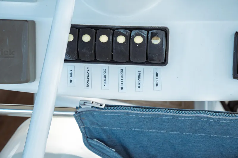 Slide: The Image of Control panel of a 2016 Beneteau Oceanis 60 sailboat with labeled switches. - 67