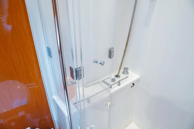 Slide: The Image of Shower area in 2016 Beneteau Oceanis 60 yacht with glass door and modern fixtures. - 7
