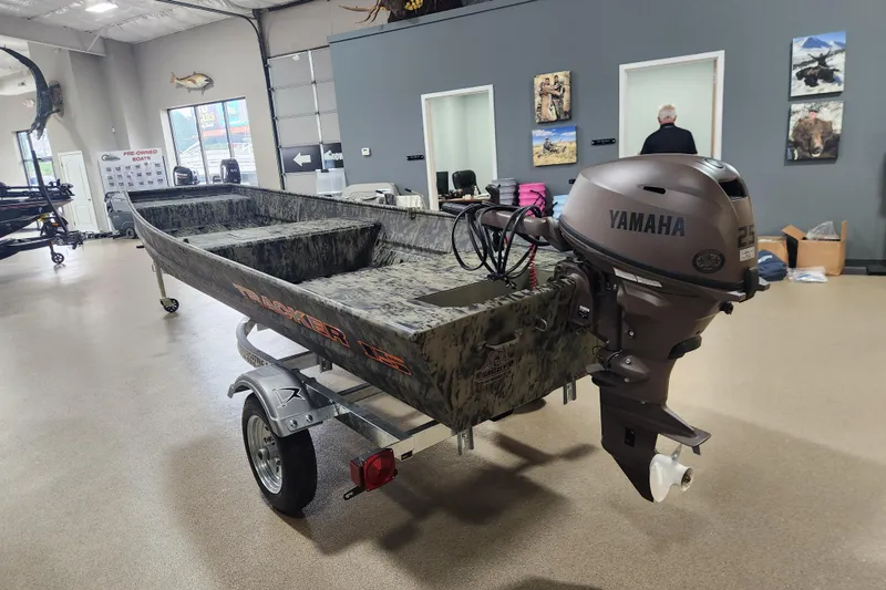 Slide: The Image of 2026 Tracker 1542 LW boat with Yamaha motor displayed indoors on a trailer. - 3