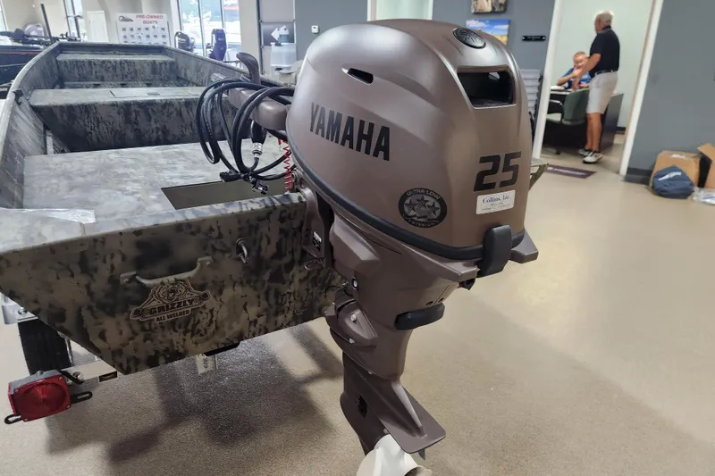 Slide: The Image of 2026 Tracker 1542 LW boat with Yamaha 25 outboard motor in showroom. - 6