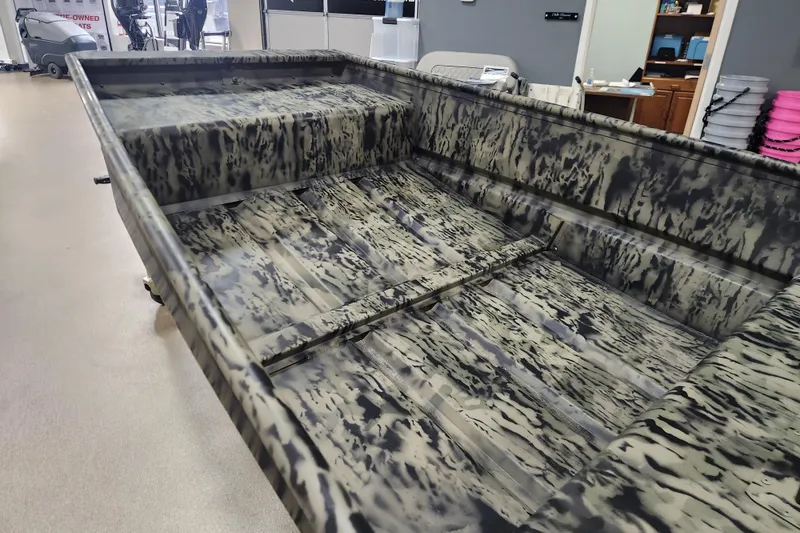Slide: The Image of 2026 Tracker 1542 LW boat with camouflage interior design in showroom. - 7