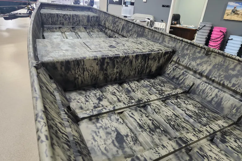 Slide: The Image of 2026 Tracker 1542 LW boat with camouflage interior design in showroom. - 8