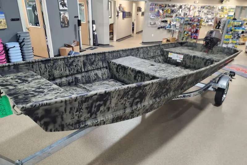 Slide: The Image of 2026 Tracker 1542 LW boat with camouflage design on display in a showroom. - 9