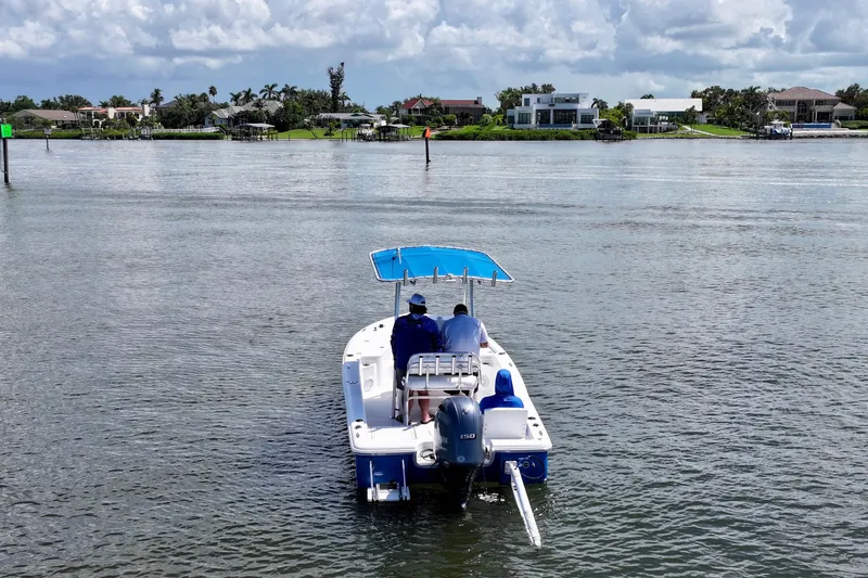 Slide: The Image of 2016 Sea Hunt BX 20 BR boat cruising on calm waters under a cloudy sky. - 10