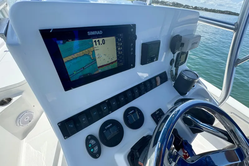 Slide: The Image of 2016 Sea Hunt BX 20 BR boat dashboard with Simrad navigation system and steering wheel. - 15