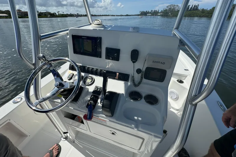 Slide: The Image of 2016 Sea Hunt BX 20 BR boat console with steering wheel and navigation equipment. - 20